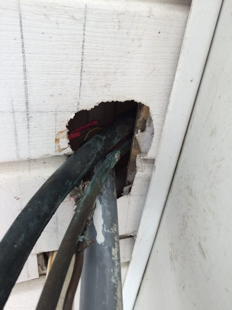 Damaged cable access hole from rodents trying to squeeze through